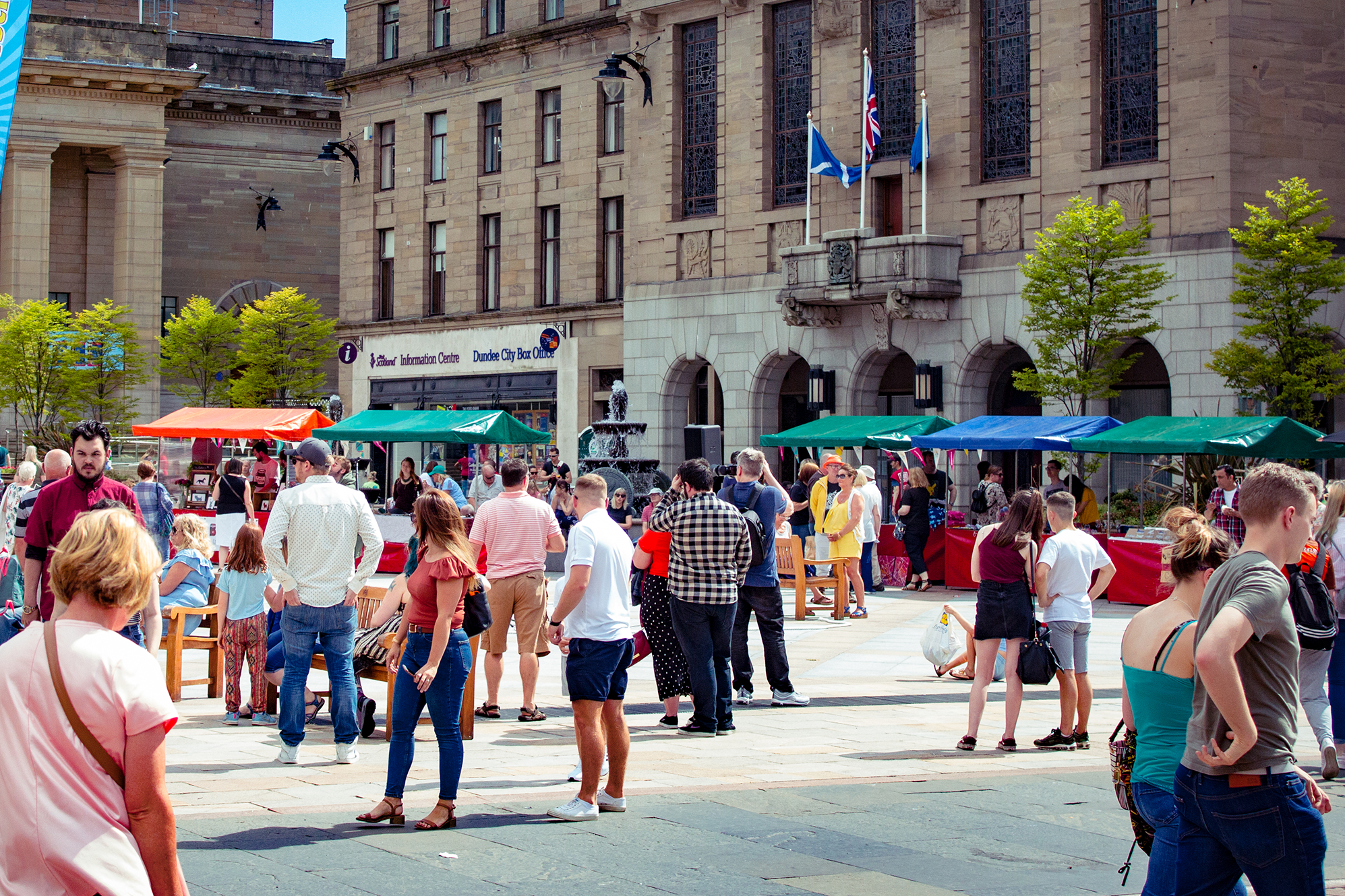 Crowd of people in city square on a sunny day