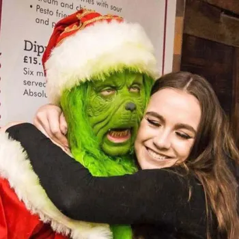 A woman hugging The Grinch