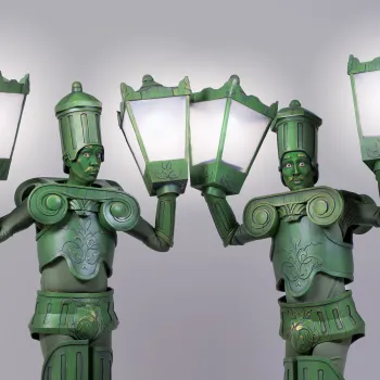 Two performers dressed in lamp post costumes