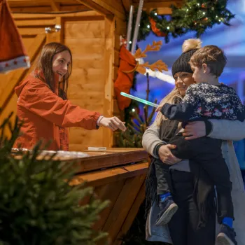 A mother and child at a market stall