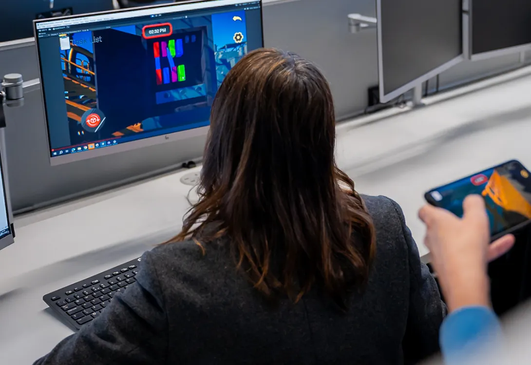 A woman playing a game on a desktop computer